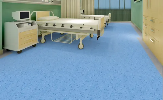 Blue vinyl flooring in a clean and modern hospital ward with patient beds and medical equipment.