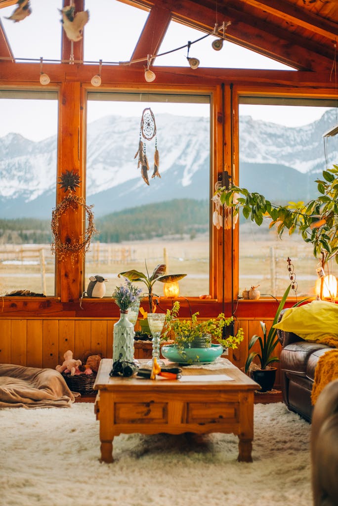Warm and natural living room with mountain views, featuring wood accents and potted plants.